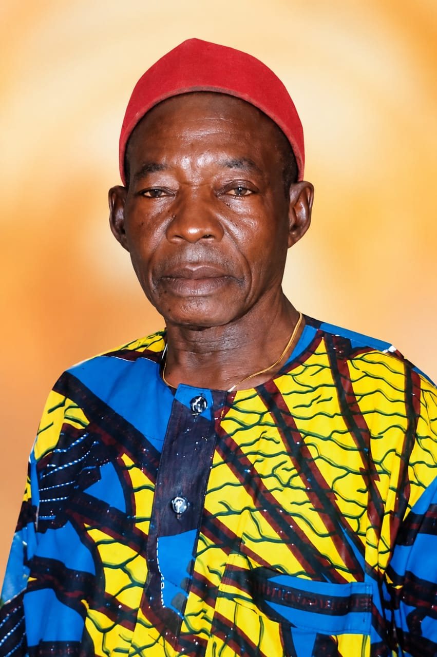 Portrait of Pa. Ogunor in a yellow and blue ankara shirt